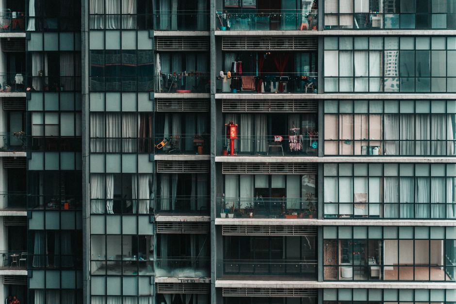 Contemporary apartment building facade with balconies and reflections in Kuala Lumpur, Malaysia. Urban lifestyle captured.